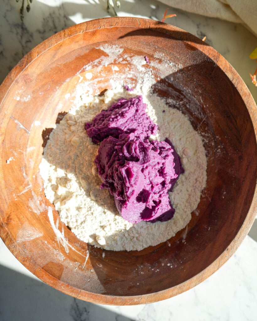 sweet potato puree on top of flour in a large bowl