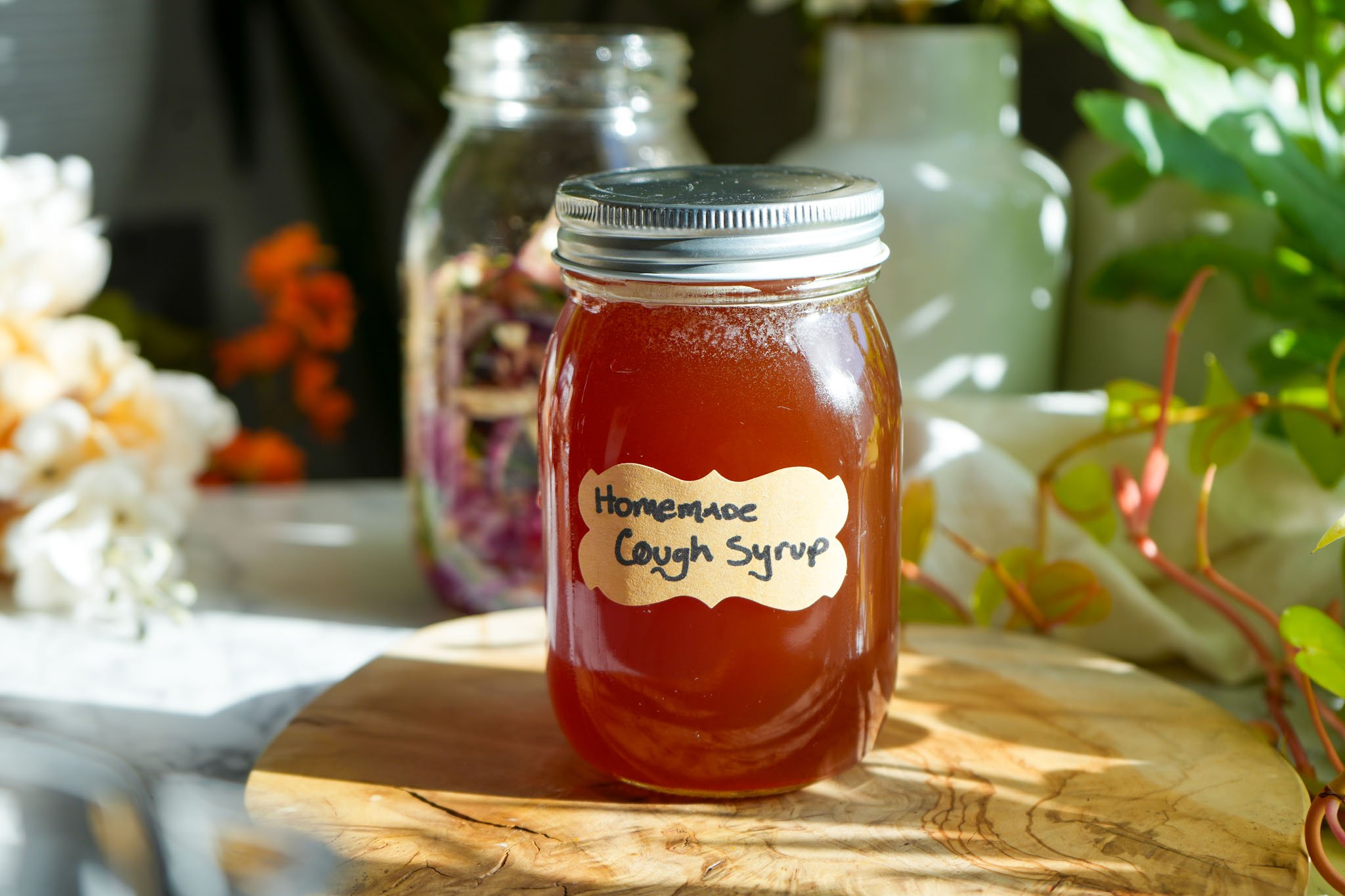 mason jar labeled and full of homemade cough syrup