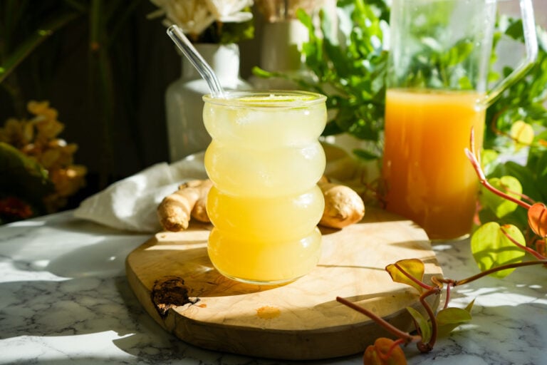 homemade ginger ale soda in a glass placed on a wooden board