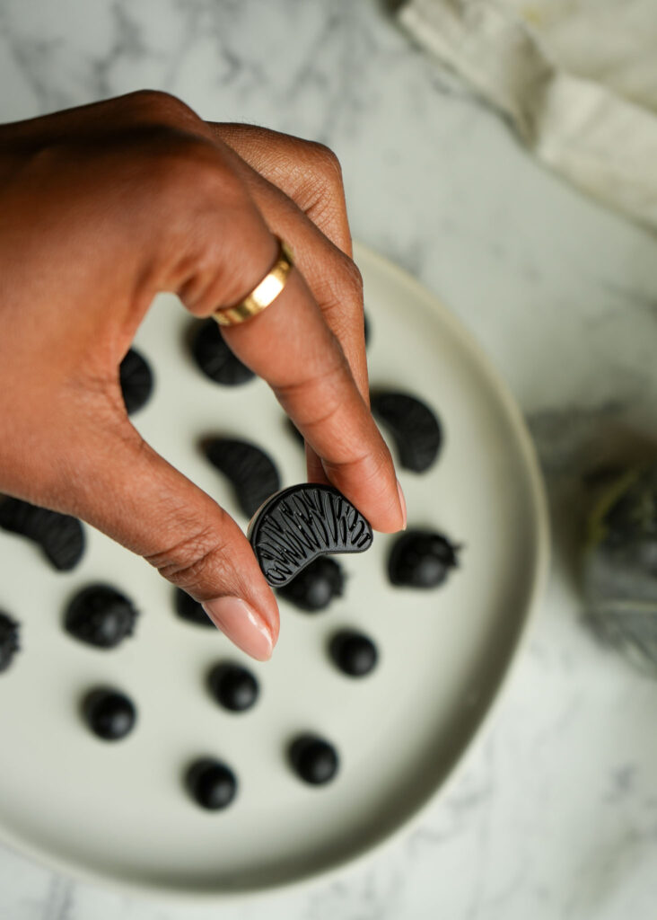 holding a homemade elderberry gummy close to show texture