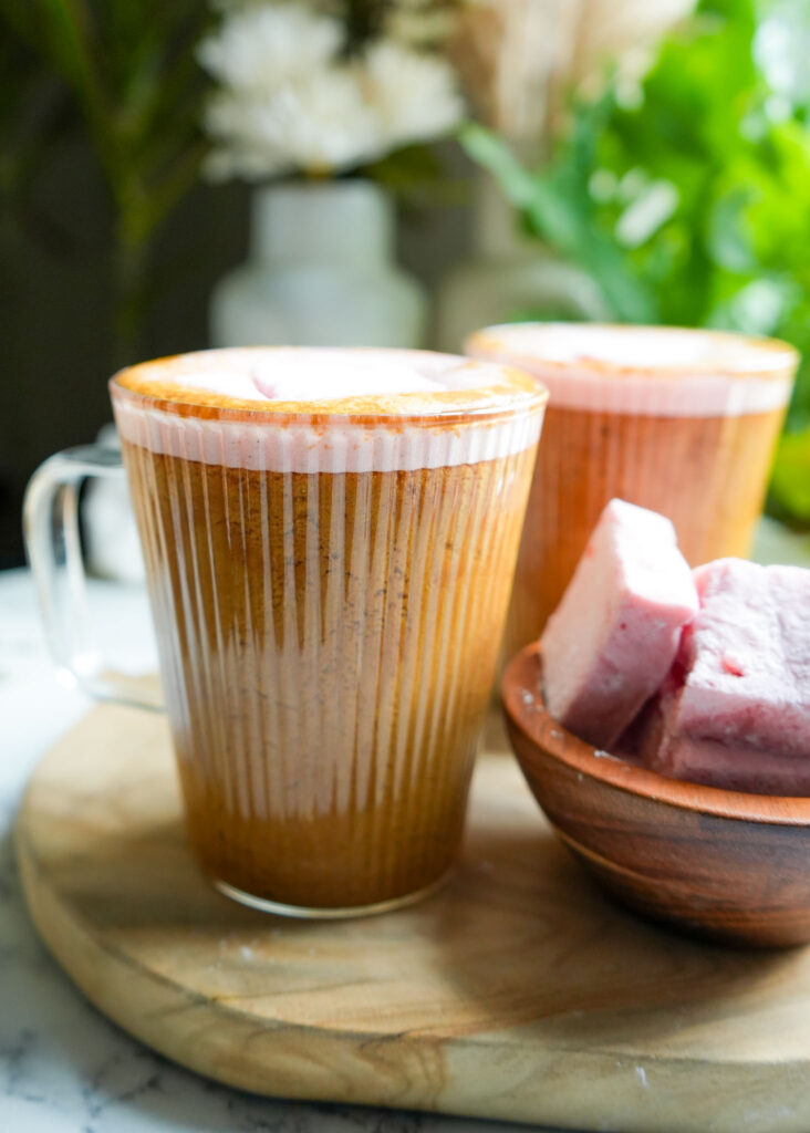 two glass mugs filled with bone broth hot chocolate and topped with homemade marshmallows