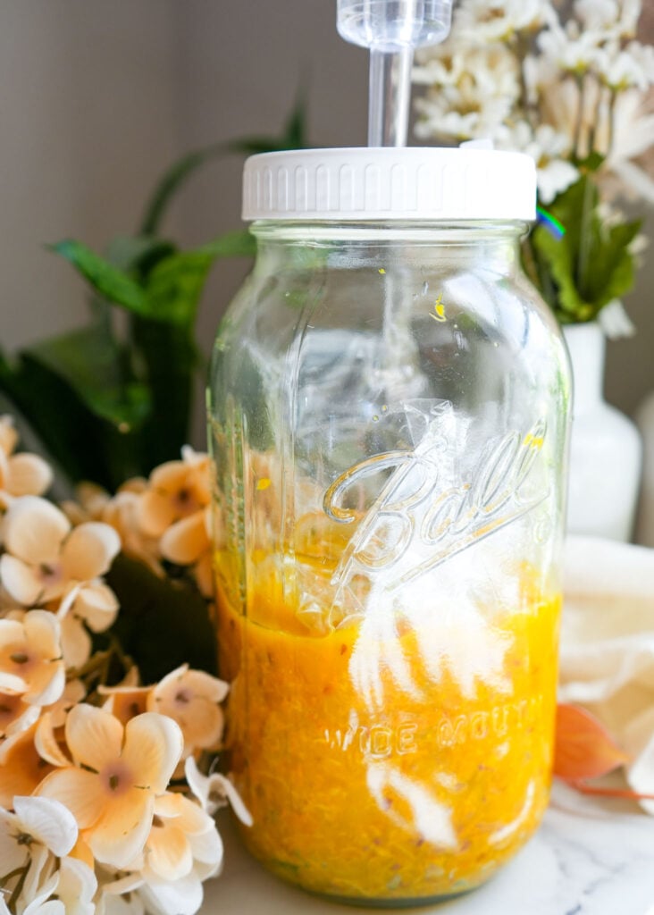 ginger turmeric sauerkraut in a large mason jar after five weeks of fermentation