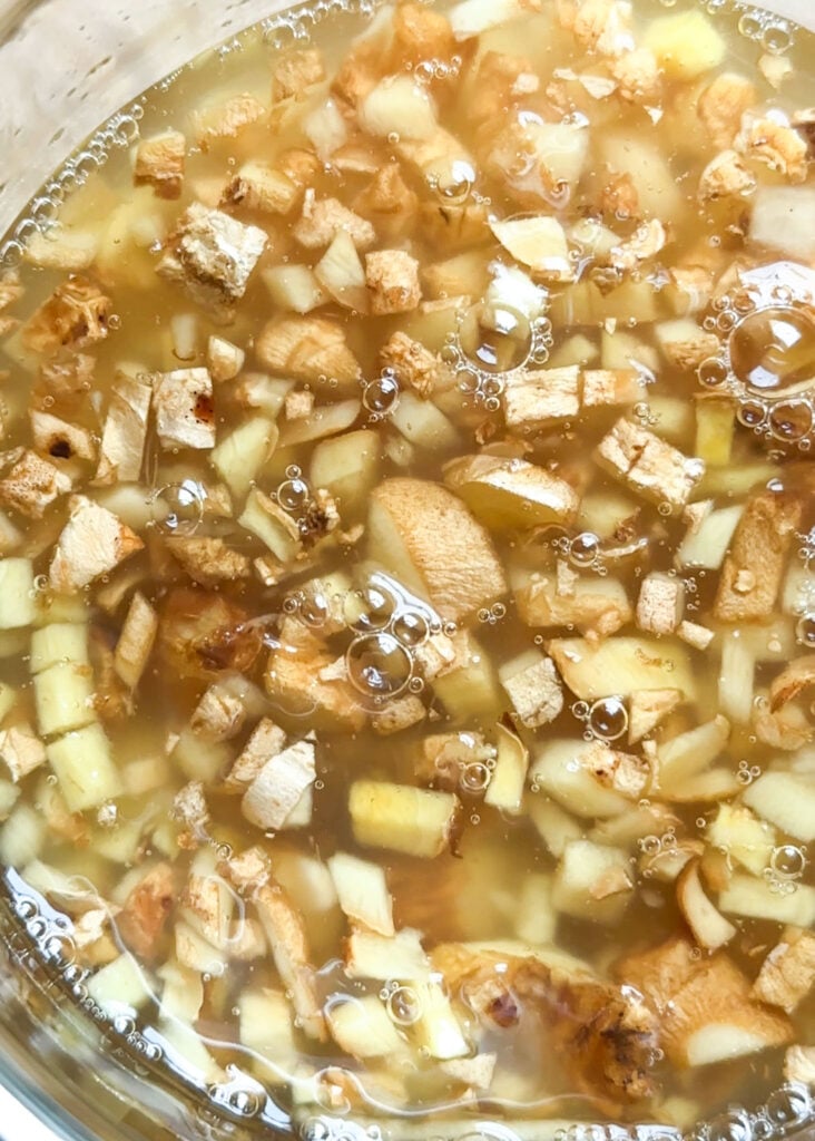 view of ginger bug made with honey and small bubbles are at the top